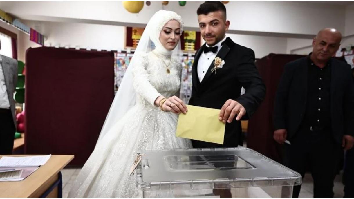 حضور یک زوج با لباس‌ عروسی پای صندوق رای